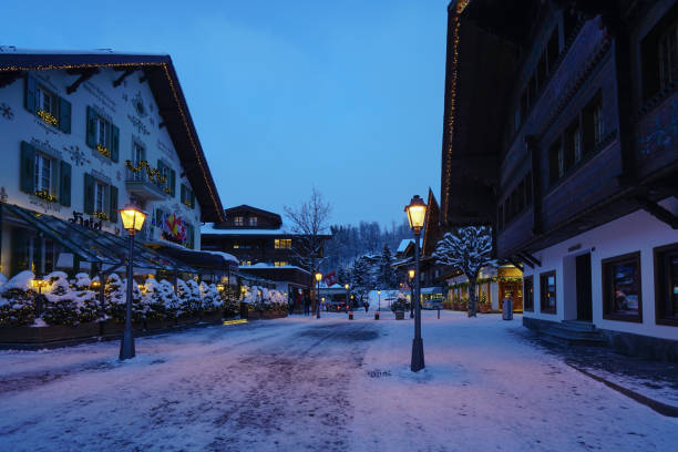 Gstaad/ Switzerland - 10.01.2019: Gstaad promenade in snow covered Gstaad village center with its chalet