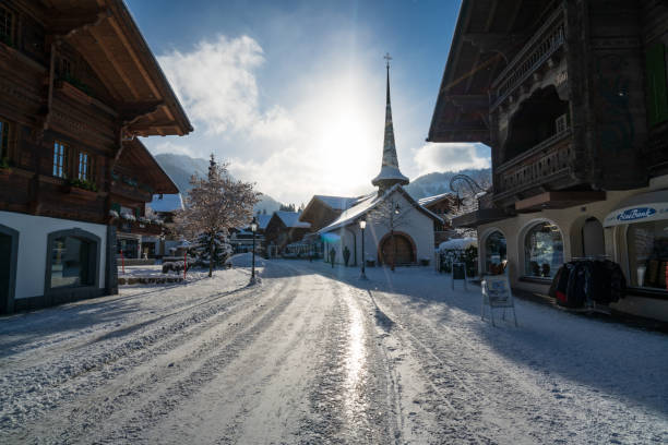 Gstaad/ Switzerland - 10.01.2019: Gstaad promenade in snow covered Gstaad village center with its chalet