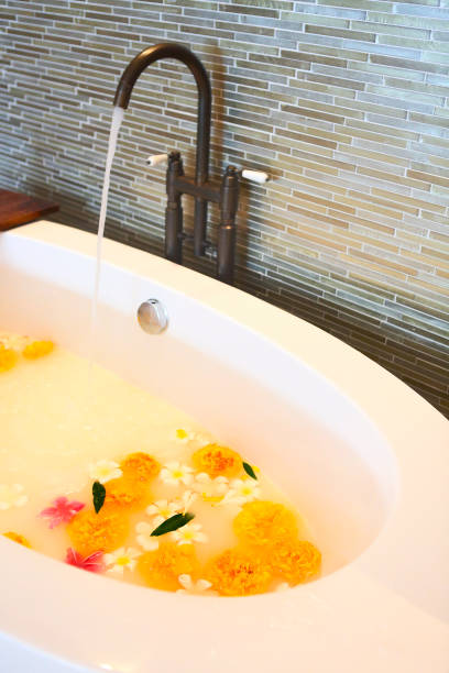 istock Elegant bath milk and flowers 1216640036
