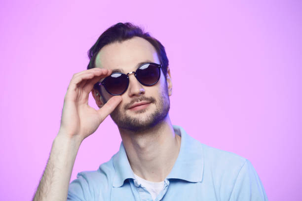 istock Studio shot of handsome man wearing sunglasses over pink background. 1216640461