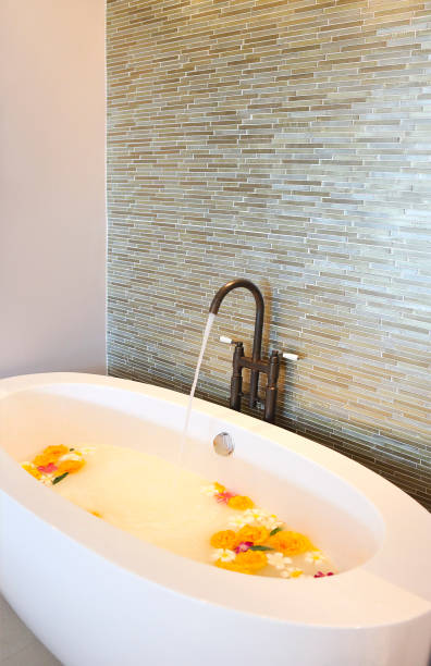 istock Elegant bath milk and flowers 1216642126