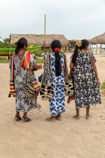 Manaure, La Guajira, Colombia, May 7, 2019: Three women who sell wayu bags have moved to a tourist place to offer their products at the Cabo de la Vela