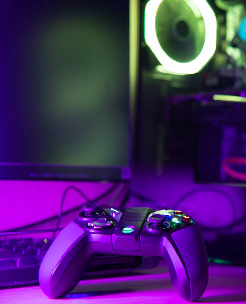 istock Close up of a game controller and glass pc case with rgb lighting 1216645746