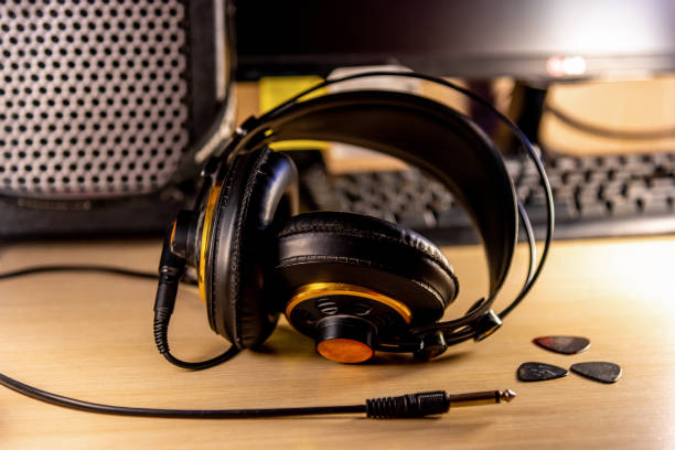 istock Headphones and guitar picks with an amplifier and a computer on the background 1216646504