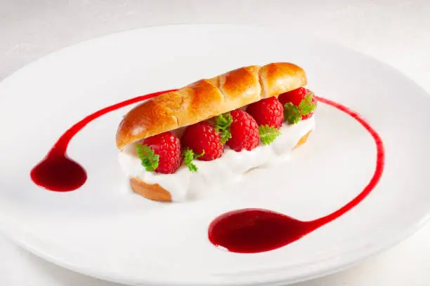 Photo of brioche with yogurt and fresh raspberries