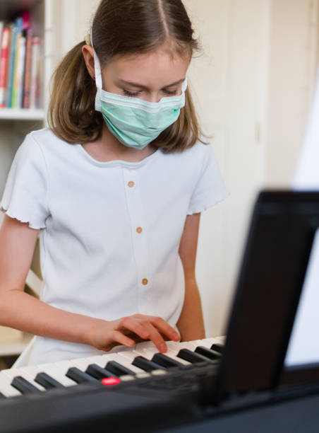 istock Little girl learning the piano during quarantine. 1216648133