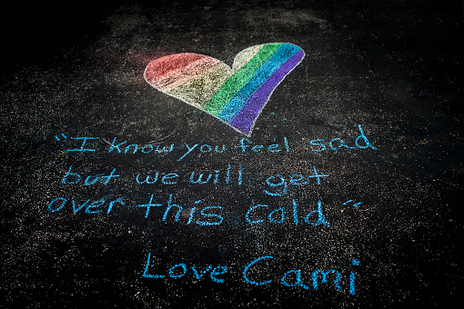 Message from a little girl written in chalk on her driveway