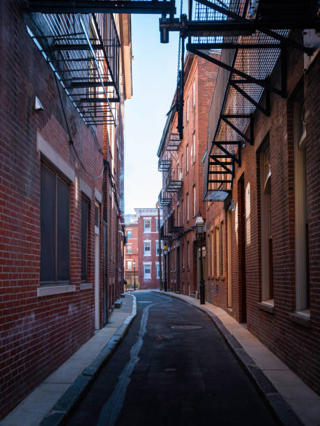 istock Narrow brick wall alley 1216648445