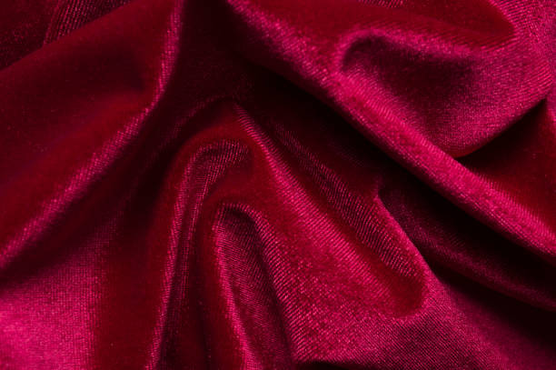 istock close up of Red cloth waves background texture 1216649699