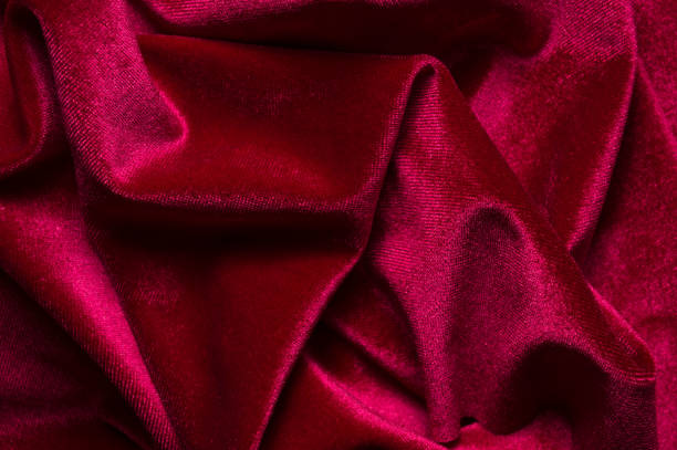 istock close up of Red cloth waves background texture 1216649701