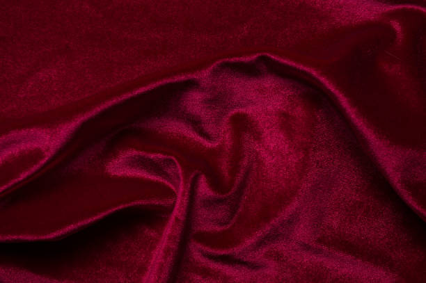 istock close up of Red cloth waves background texture 1216649719