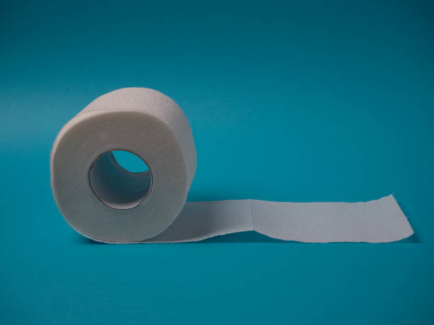 istock Toilet paper roll on a blue background close up with copy space. 1216650104