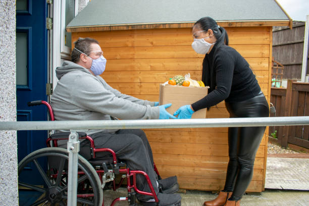 Delivering Food to the Disabled in Quarantine During Covid-19 Coronavirus Pandemic stock photo
