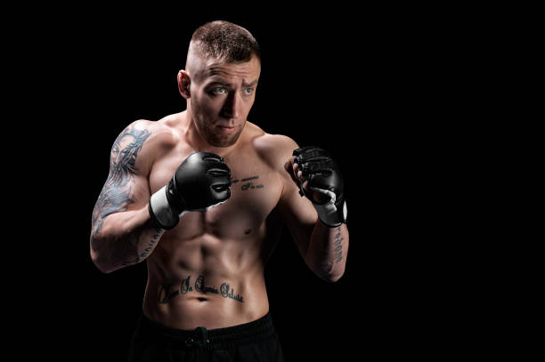 Mixed martial artist posing on a black background. Concept of mma, ufc, thai boxing, classic boxing. stock photo