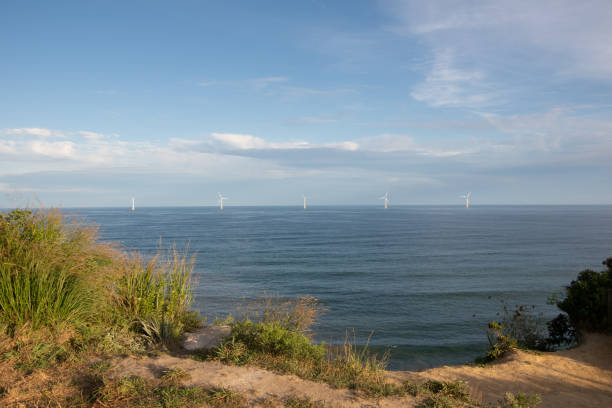 Block Island Wind Farm from Bluff A windmill farm off the south eastern coast of Block Island. Block Island Wind Farm is the first commercial offshore wind farm in the US. It was built from 2015-2016 and consists of five turbines. offshore wind farm stock pictures, royalty-free photos & images