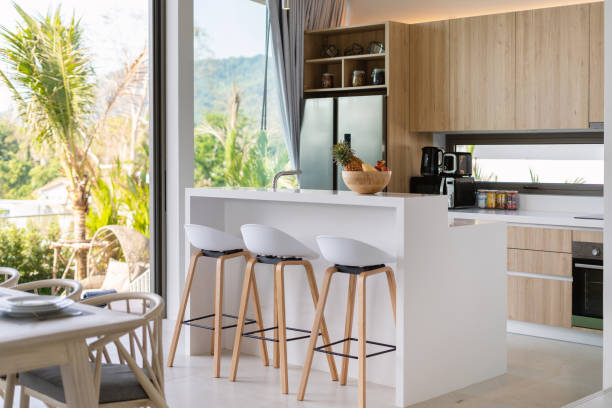 istock Interior design in villa, house, home, condo and apartment feature kitchen counter, bar stool, oven and refrigerator in kitchen 1216654166