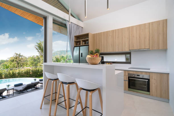 istock Interior design in villa, house, home, condo and apartment feature kitchen counter, bar stool, oven and refrigerator in kitchen 1216654171