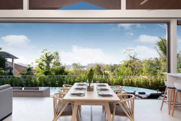 istock Interior design in pool villa, house and home feature dining table and dining chair in dining room with pool view 1216654264