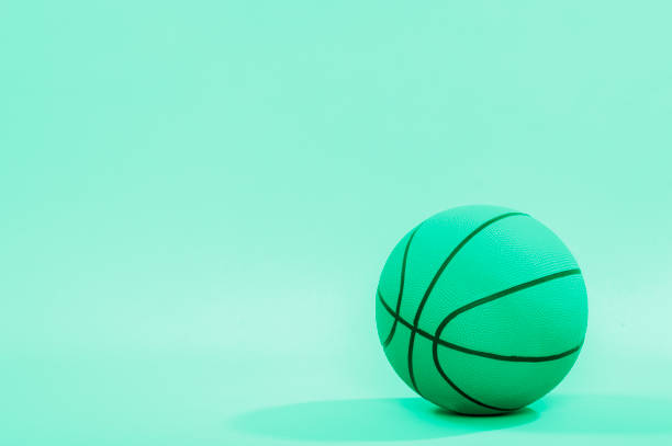 istock Basketball ball isolated on green background. 1216655576