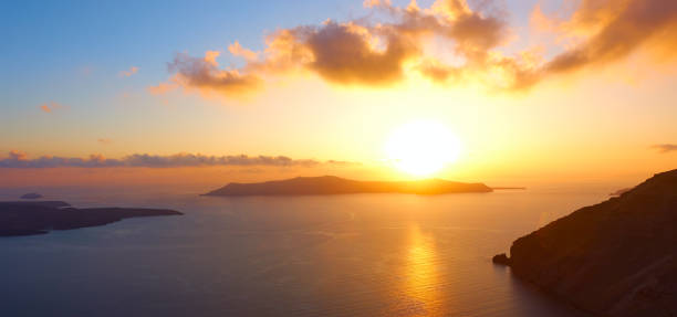 istock Panoramic view of sunset over the sea in Santorini 1216656255