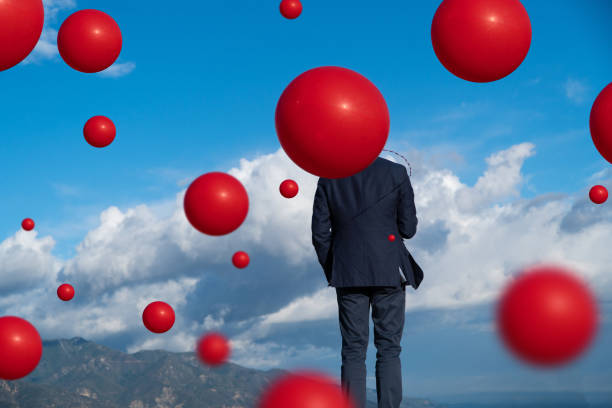 istock Floating Coronavirus balloons with Young Man 1216658358