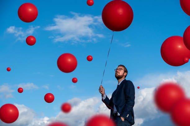 istock Floating Coronavirus balloons with Young Man 1216658434
