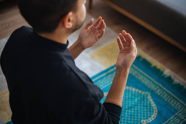 Muslims prayer at home stock photo