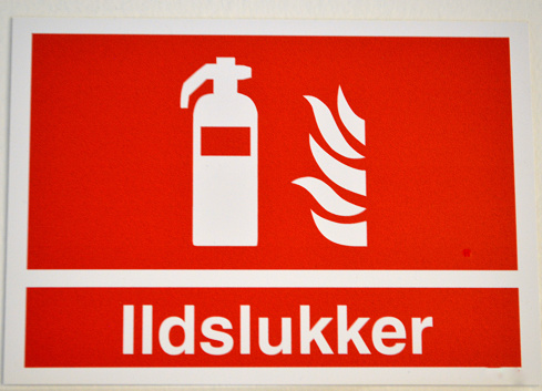 Flammable sign on the white wall background. Flammable materials sign