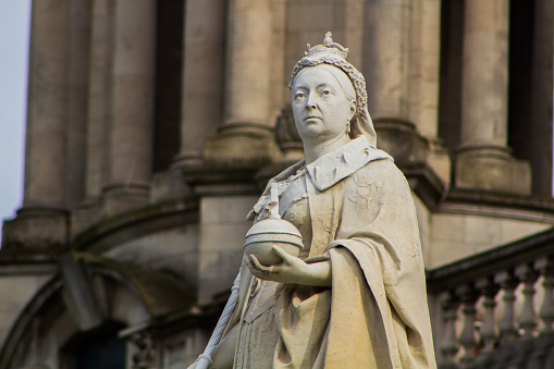 David Hume Statue with St. Giles Cathedral on the background on Royal Mile in Edinburgh, Scotland