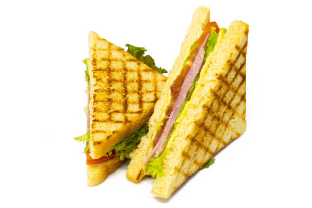 istock Sandwich with ham, cheese, tomatoes, lettuce, and toasted bread. Front view isolated on white background 1216663843