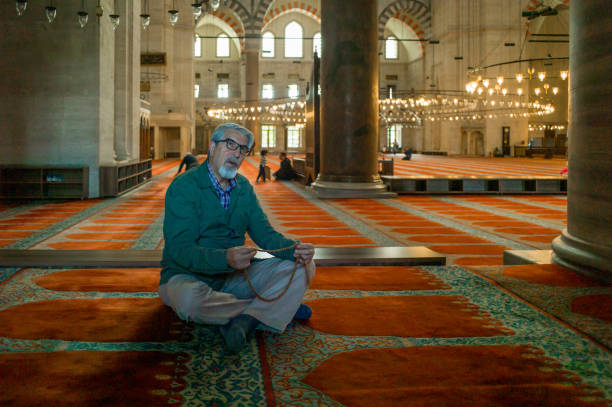 istock Senior muslim man with prayer beads praying 1216663947
