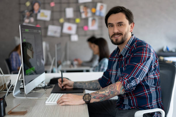 istock Happy graphic designer working at the office 1216664152