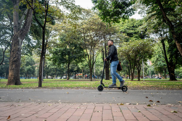 istock Young man riding a scooter at the park 1216664796