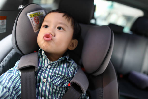 istock Happy boy is secure in a baby car seat 1216665131