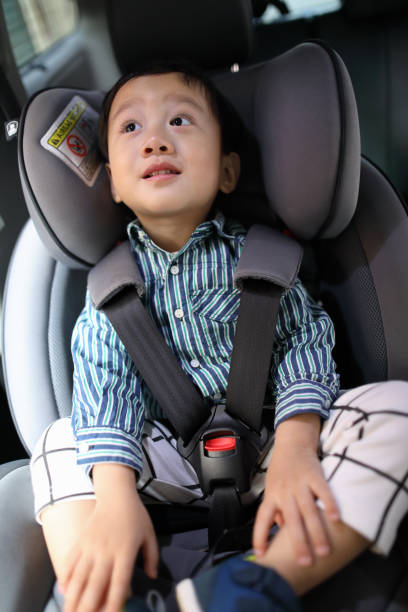 istock Happy boy is secure in a baby car seat 1216665181