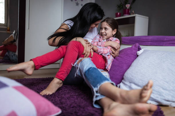 istock Young girl being tickled by her cousin 1216665355