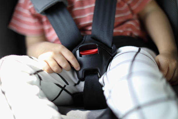Happy boy is secure in a baby car seat stock photo