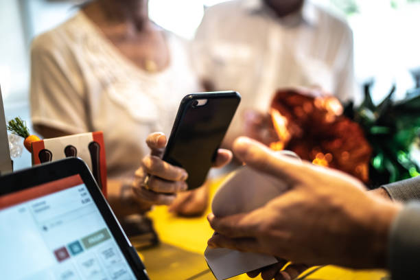 istock Senior woman paying by mobile in a store 1216668409