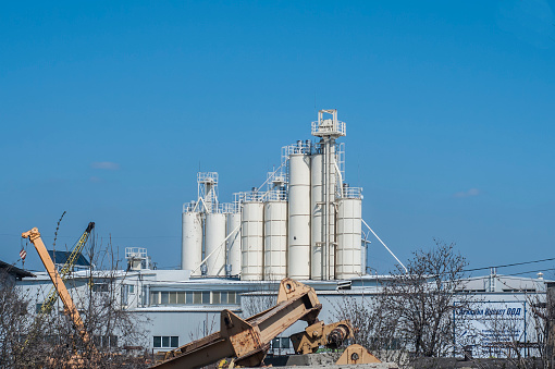 Cement silo tanks as industrial landscape in clear sunny day