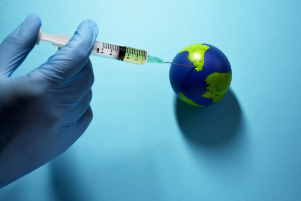 istock Global vaccination, Doctor makes an injection to planet earth 1216668544