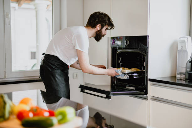 istock Young man baking pastries in the kitchen at home 1216670215
