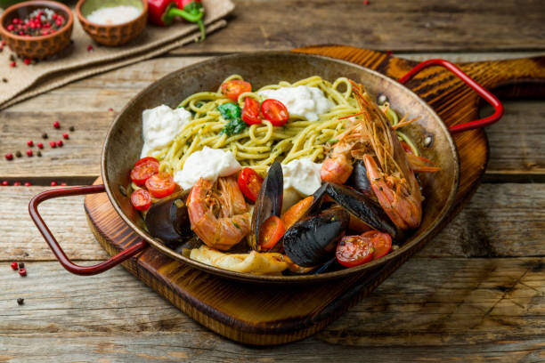 istock Pasta with seafood on old wooden table 1216670339