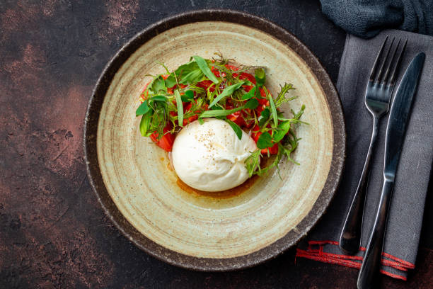 istock Salad with buratta cheese on dark plate 1216671352