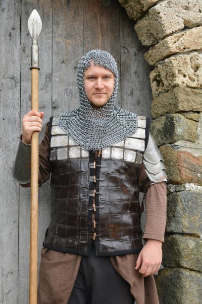 istock Young knight on guard at castle's gate 1216671489