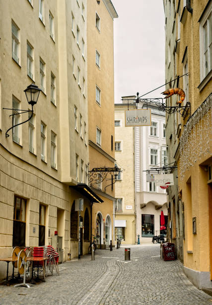 Salzburg, Austria - May 26, 2019: One of Salzburg's oldest narrow streets, the Steingasse, is kept clear of vehicular traffic by a bollard (cylinder) rising up from the paving stones.