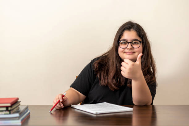 istock 13 years old girl doing homework 1216675291