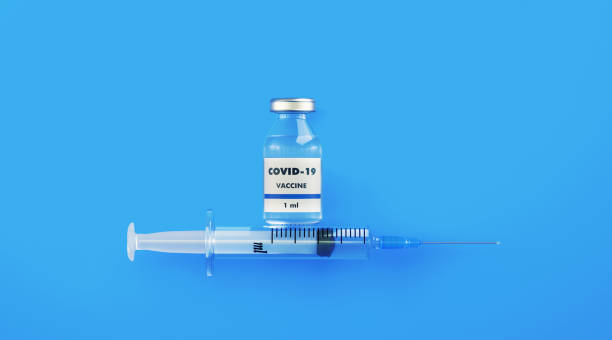 istock COVID-19 Vaccine and Syringe on Blue Background 1216676255