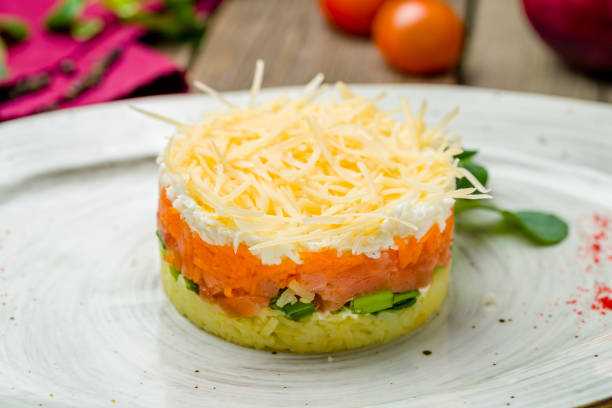 istock Mimosa salad on a plate on wooden table 1216676262