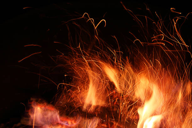 istock Defocused Background. Fire flame and sparks on a black background. Close-up. 1216678288