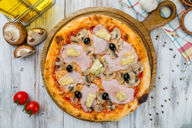 istock Capricciosa pizza with artichokes on white wooden table 1216678391